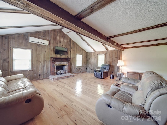 living room with a textured ceiling, wood walls, light hardwood / wood-style floors, and a wall mounted air conditioner