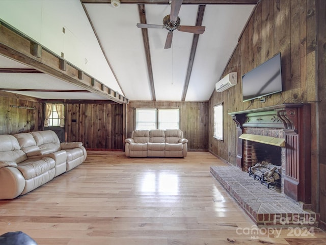 living room featuring light wood-type flooring, a wall mounted AC, wood walls, and lofted ceiling with beams