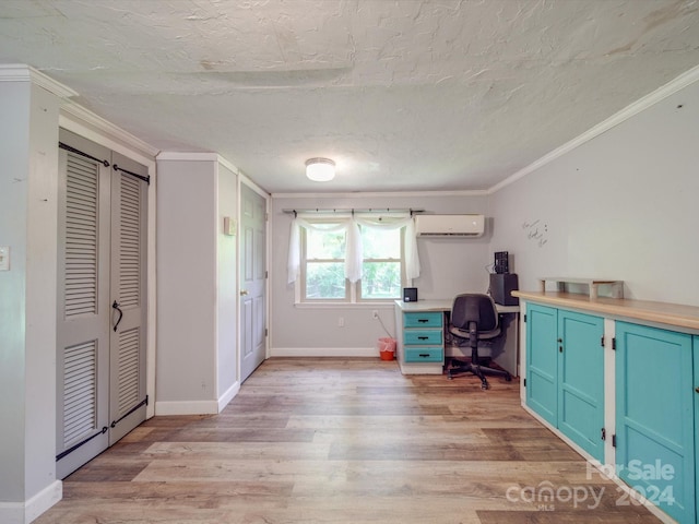 unfurnished office featuring light wood-type flooring, an AC wall unit, crown molding, and a textured ceiling