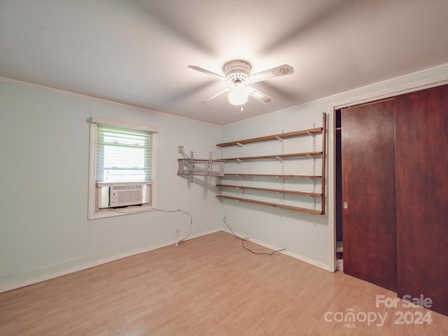 unfurnished bedroom with ceiling fan, cooling unit, ornamental molding, and light wood-type flooring