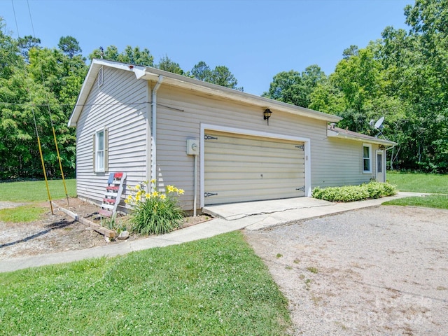 exterior space with a garage and a yard