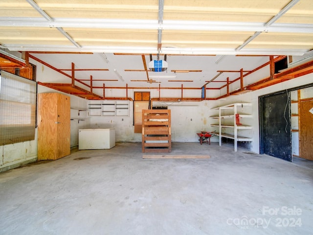 garage featuring refrigerator and a garage door opener