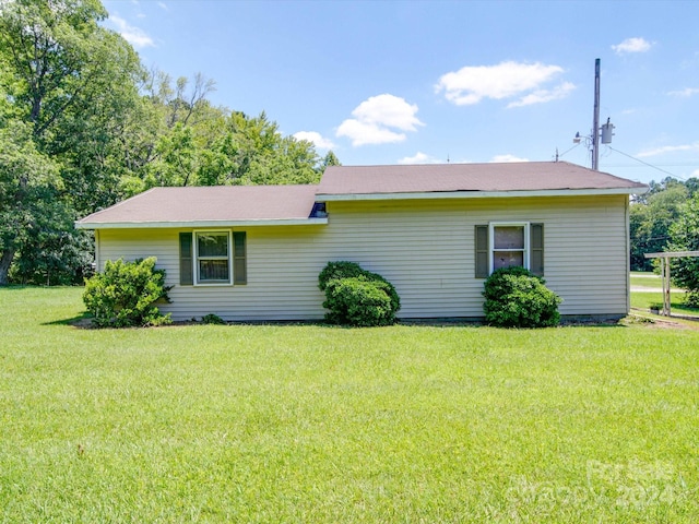 view of side of home featuring a lawn