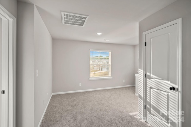 unfurnished bedroom with light colored carpet