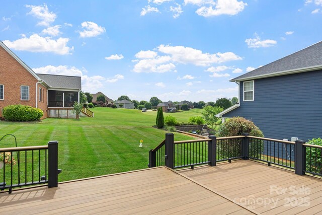 wooden terrace with a sunroom and a yard