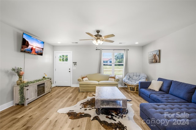 living room with ceiling fan and light hardwood / wood-style floors