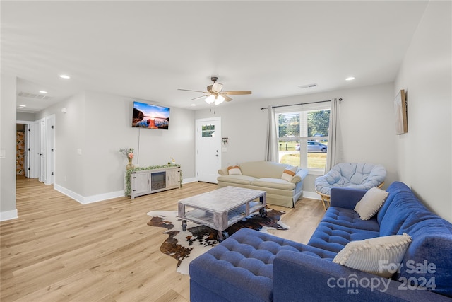 living room with ceiling fan and light hardwood / wood-style floors