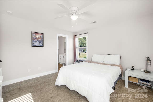 bedroom featuring ceiling fan, carpet, and ensuite bathroom