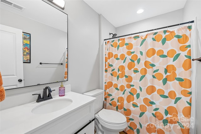 bathroom featuring toilet, vanity, and a shower with shower curtain