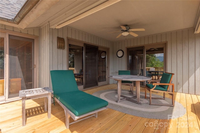 wooden deck featuring a ceiling fan and outdoor dining space