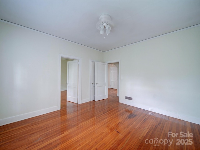 unfurnished room with hardwood / wood-style floors