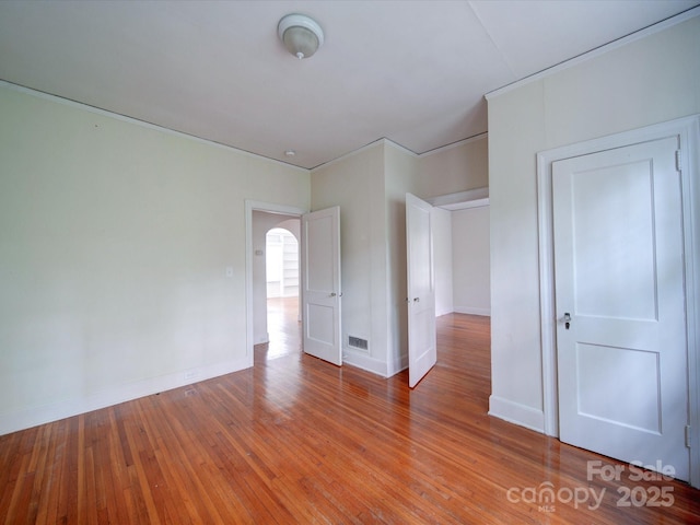 spare room with hardwood / wood-style flooring