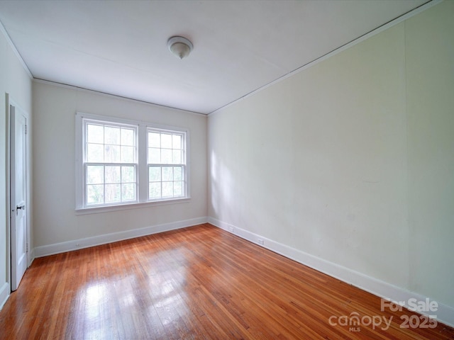 unfurnished room with crown molding and light hardwood / wood-style floors