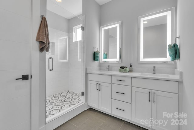 bathroom featuring tile patterned flooring, vanity, and a shower with shower door