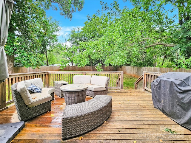 wooden terrace with an outdoor hangout area and a grill