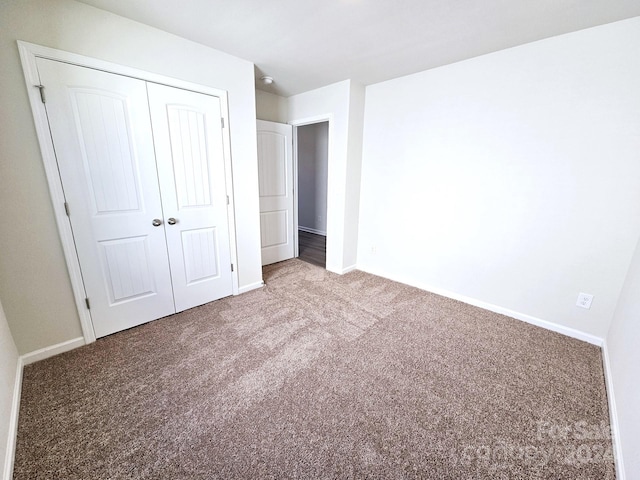 unfurnished bedroom featuring a closet and carpet