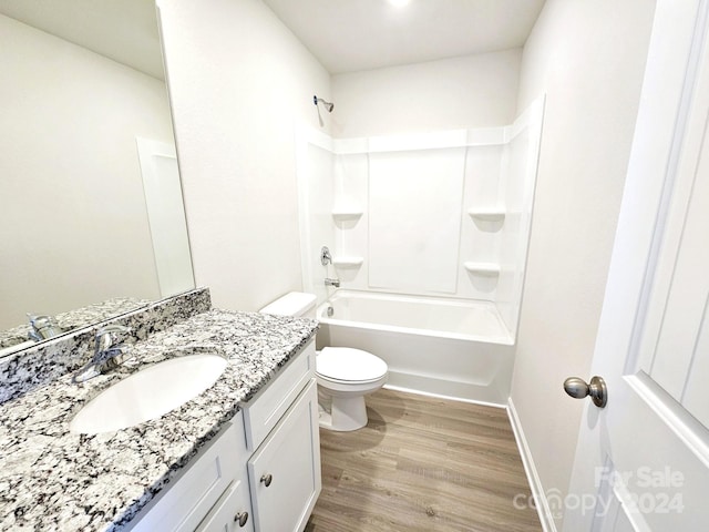 full bathroom with toilet, hardwood / wood-style floors, vanity, and bathing tub / shower combination