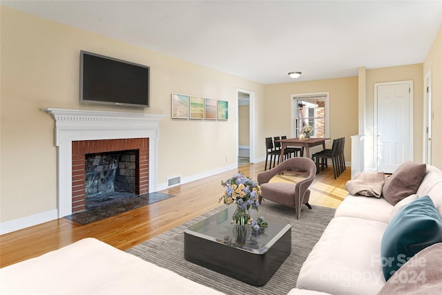 living room featuring a fireplace and hardwood / wood-style floors