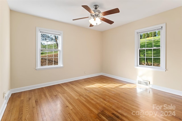 unfurnished room featuring ceiling fan and hardwood / wood-style floors