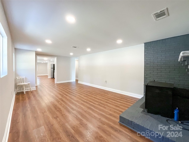 living room with hardwood / wood-style floors and a fireplace