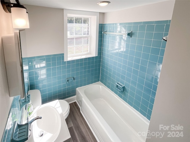 bathroom featuring toilet, hardwood / wood-style flooring, and tile walls