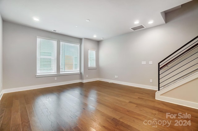 unfurnished room with dark hardwood / wood-style floors