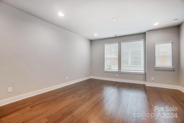 unfurnished room featuring dark hardwood / wood-style floors