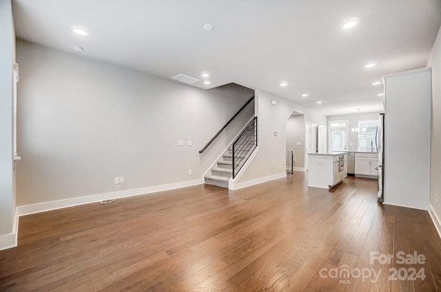 unfurnished living room featuring hardwood / wood-style flooring