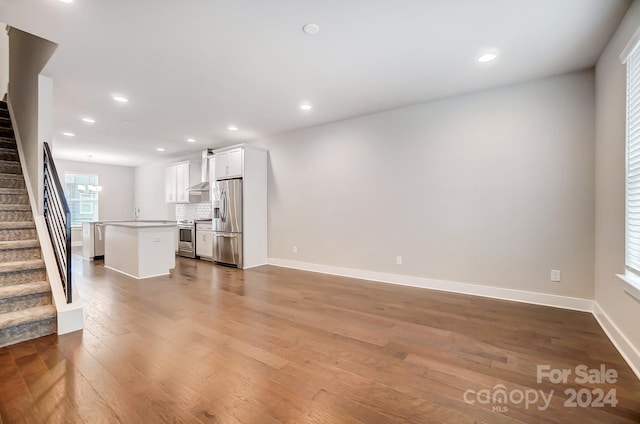 unfurnished living room with hardwood / wood-style floors