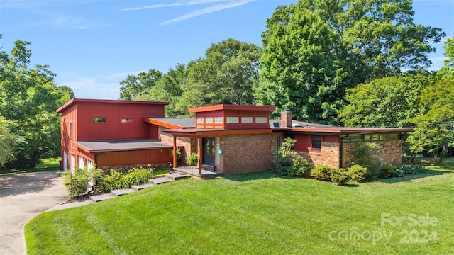 view of front of house with a garage and a front lawn