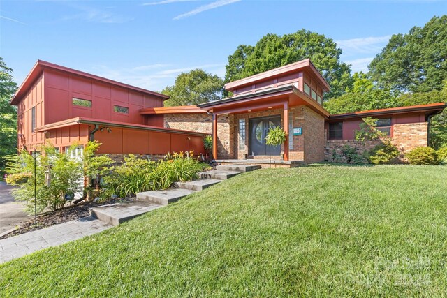 contemporary home with a front lawn