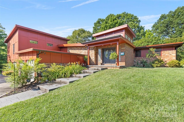 contemporary home featuring a front lawn