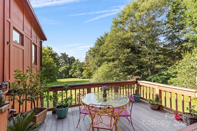 wooden terrace featuring a yard