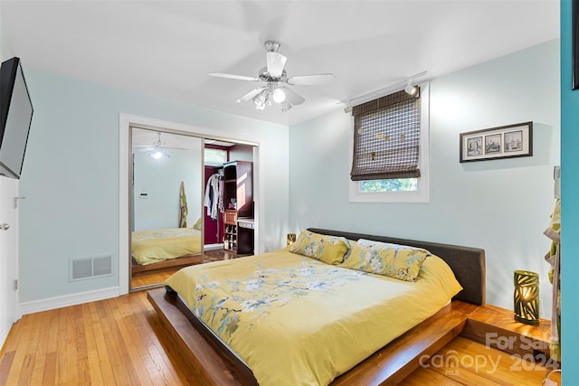 bedroom with a closet, wood-type flooring, and ceiling fan