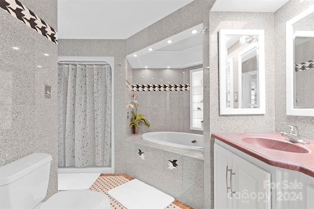 full bathroom with toilet, tile walls, and shower with separate bathtub