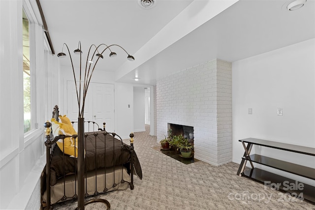 bedroom with a fireplace and carpet flooring