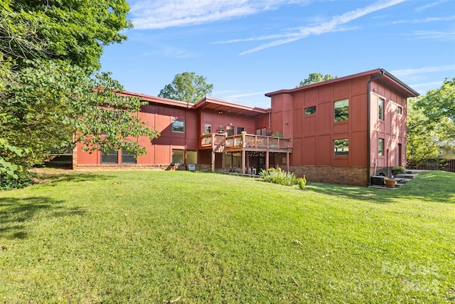 exterior space featuring a lawn and a wooden deck