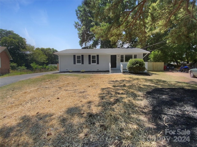 ranch-style house with a front lawn