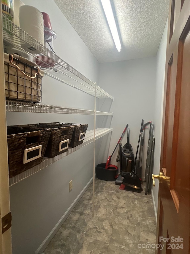 laundry area with a textured ceiling