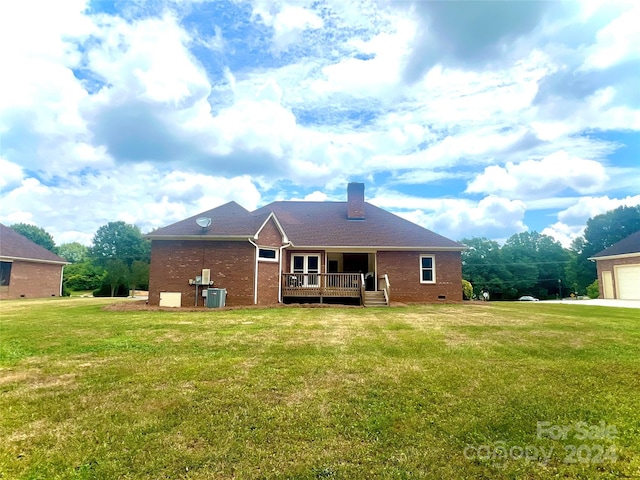 back of house with cooling unit and a yard