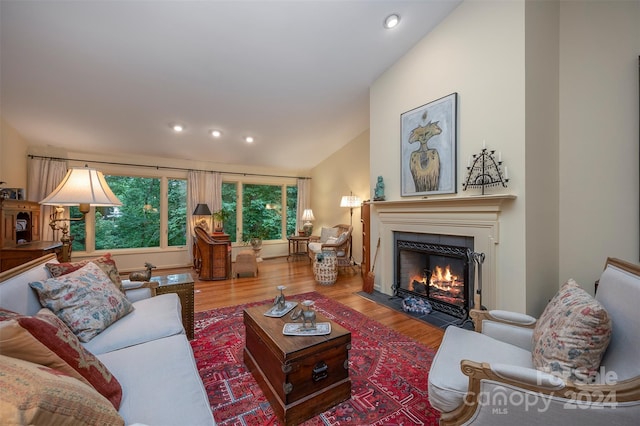 living room featuring vaulted ceiling and hardwood / wood-style floors