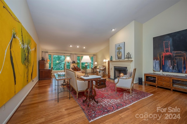 living room with vaulted ceiling and hardwood / wood-style floors