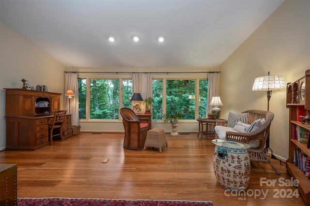 living area with lofted ceiling and light hardwood / wood-style floors