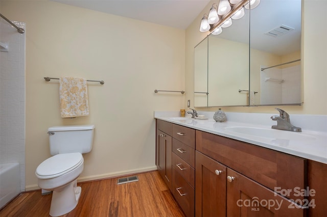 bathroom featuring vanity, hardwood / wood-style flooring, and toilet