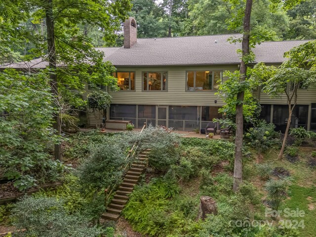 back of property featuring a sunroom