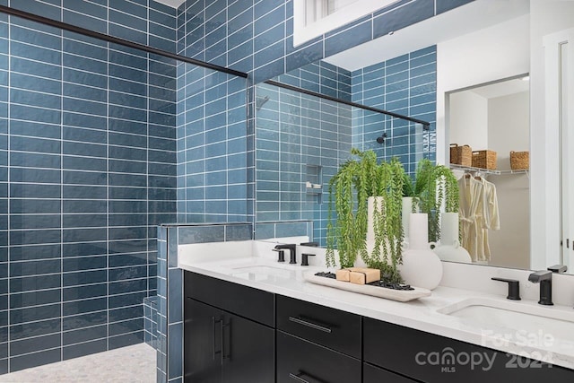 bathroom featuring vanity and tiled shower