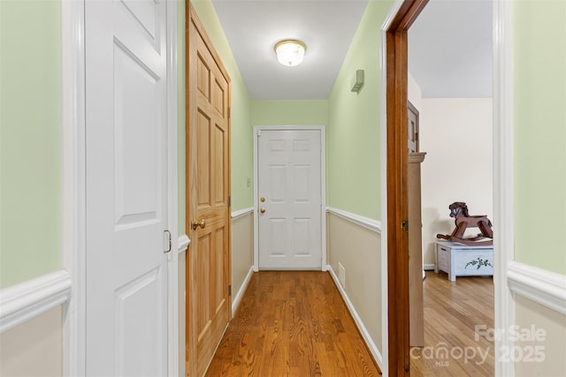 hallway with light hardwood / wood-style floors