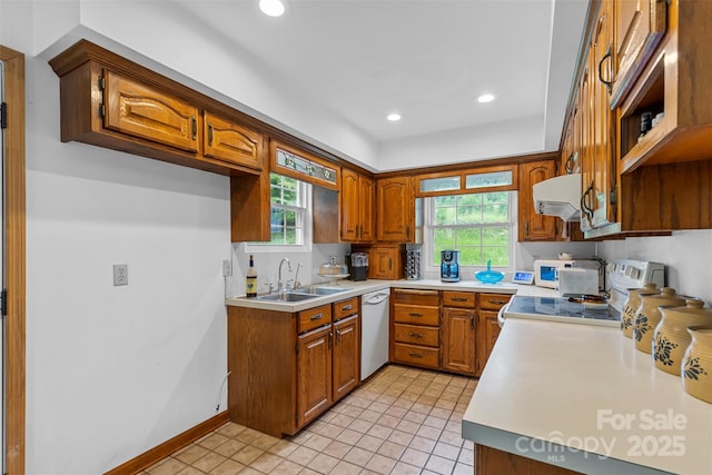 kitchen featuring stove, a wealth of natural light, white dishwasher, extractor fan, and sink