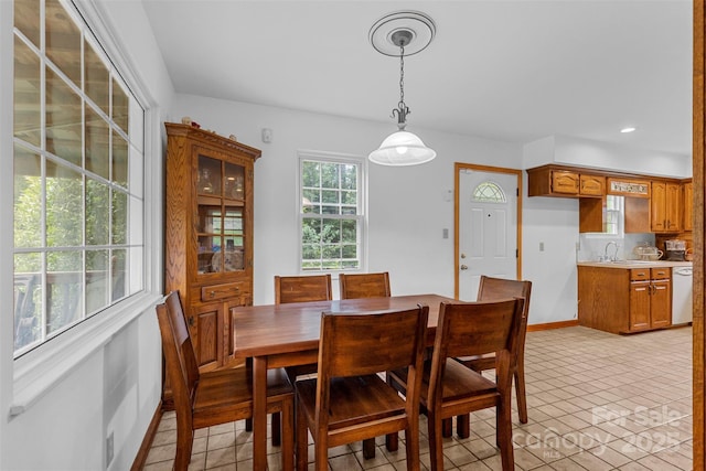 tiled dining room featuring sink