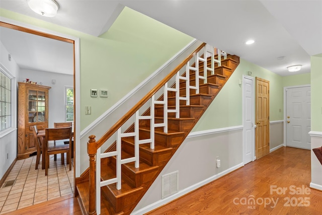 staircase with hardwood / wood-style floors